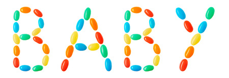 Baby lettering made of multicolored candies isolated on white backgroundの写真素材