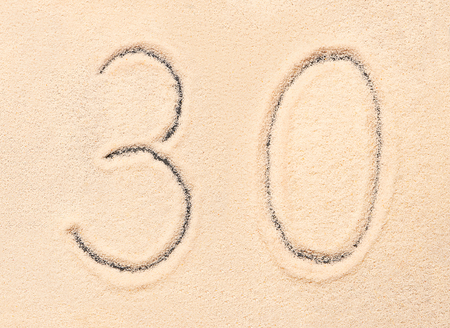 30 number written on sand. Summer beach background