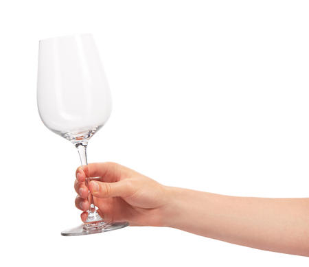 Close up of female hand holding empty clean transparent wine glass against white background.の写真素材