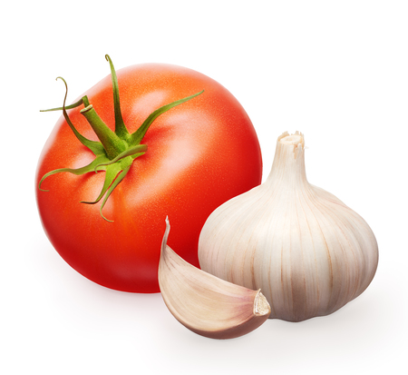 Whole fresh red tomato with green leaf and garlic with clove isolated on white backgroundの写真素材