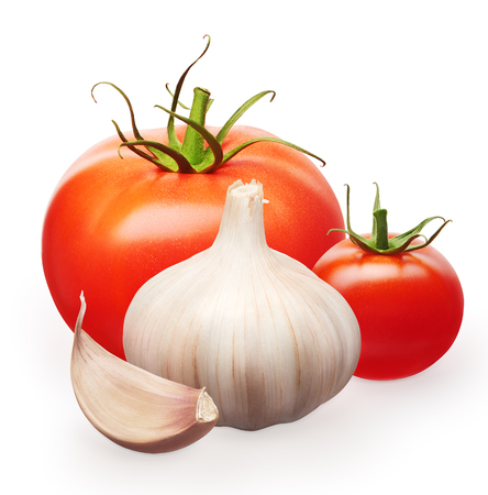Whole fresh red and small cherry tomatoes with green leaves and garlic with clove isolated on white backgroundの写真素材