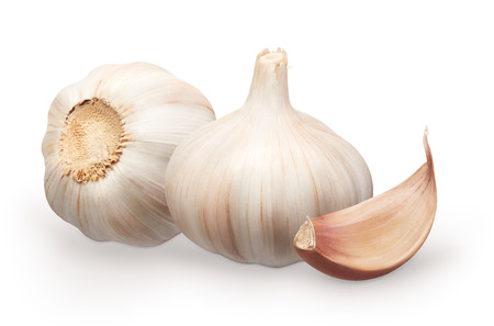 Whole fresh garlic next to garlic lying on its side and clove isolated on white backgroundの写真素材