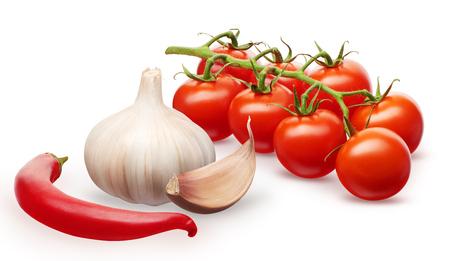 Branch of fresh red cherry tomatoes with green leaves, garlic with clove and red chili pepper vegetables isolated on white backgroundの写真素材