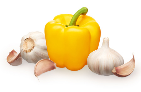 Whole fresh yellow bell pepper and garlic with cloves isolated on white backgroundの写真素材