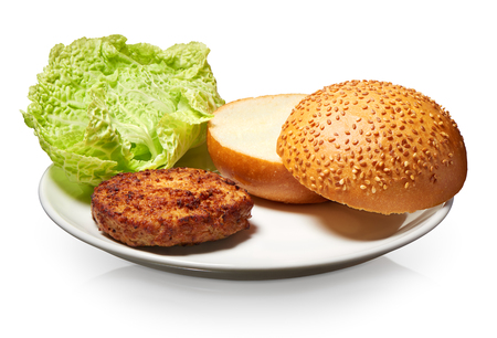 Hamburger, fresh bun with sesame seeds and lettuce on white plate isolated on white background. Clipping path includedの写真素材