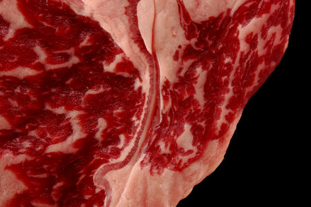 Close up of marbled beef steak isolated on black backgroundの写真素材
