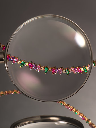 Artistic photography of luxury gold necklace with natural colorful gemstones. Love and wedding concept.の写真素材