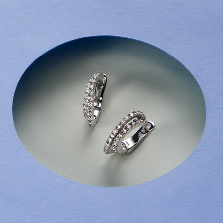 Artistic photography of luxury earrings with natural diamonds. Love and wedding concept.の写真素材