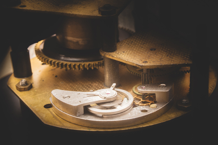 Part of clockwork golden color. Gears rotating each other