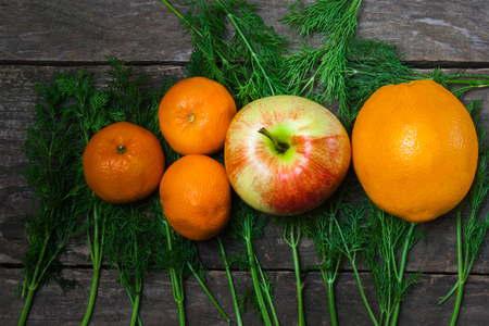 Apple and citrus on a background of a wooden tableの写真素材
