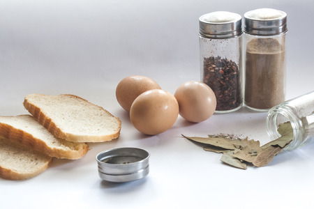 Bread seasoning and eggs on the sunny kitchenの写真素材