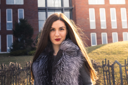 Street photosession of the girl, in a big city, in different places. Portraits on a background of modern and retro buildingsの写真素材
