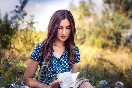 portrait of a woman in an autumn field with flowersの写真素材