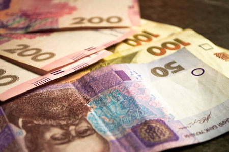 Money and banknotes on a dark stone background, taken with various objects