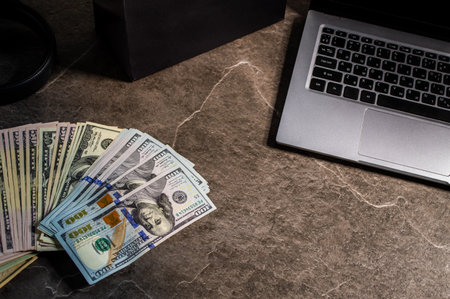 Money and banknotes on a dark stone background, taken with various objectsの写真素材