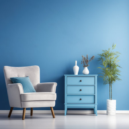 Blue armchair against white dresser in modern living room. Home interior design with blue stucco wallの素材