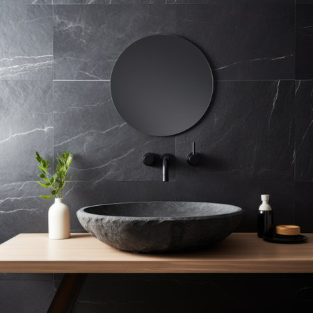 Stylish black marble round vessel sink and wall mounted faucet on stone wall. Interior design of cute modern bathroomの素材
