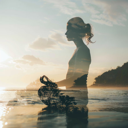 Silhouette of a pregnant woman with a tree in her hands on the beach at sunsetの素材