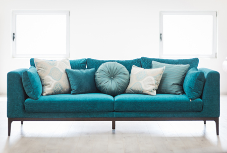 Bright living room interior with blue sofa and cushionsの写真素材