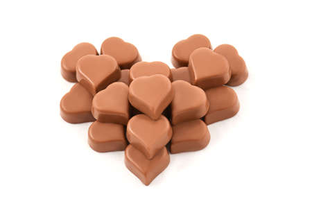 milk chocolate in the shape of a heart on white backgroundの写真素材