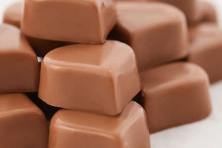 milk chocolate in the shape of a heart on white background