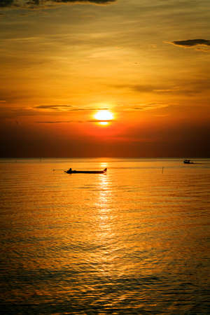 Sunrise beach with fishing boat at Prachuap Khiri Khan Province, Thailandの写真素材
