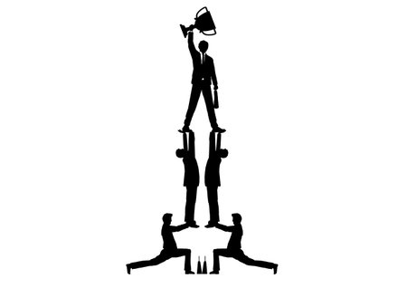 Silhouette of a businessman holding a trophy on a pedestalの写真素材