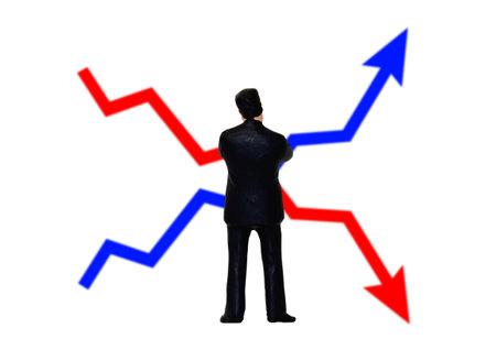Businessman standing on a chart with red and blue arrows isolated on white background
