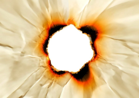 Burning hole in the paper. Isolated on white background.の写真素材