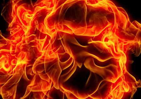 Fire flames on a black background close-up, abstract background.