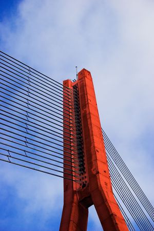 Modern Red Cable bridge closeup on blue skyの写真素材