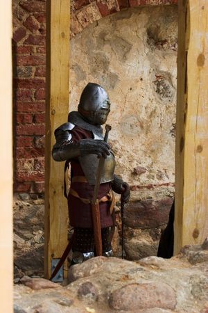 Armoured knight with sword in medieval festival after batleの写真素材