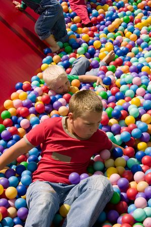Two boys playing in playground colourful ball poolの写真素材