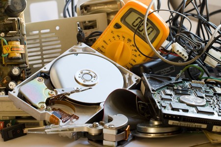 Pile of Old computer parts and hard disks