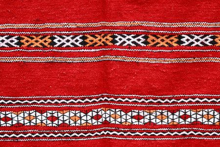Red ethnographical handmade blanket with color pattern.
の写真素材