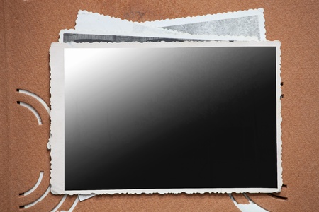 Blank photo frame on a stack of old photos. Clipping path included for eassy issolationの写真素材