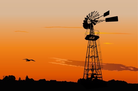 Silhouette of a vintage water pumping windmill against sunset skyのイラスト素材