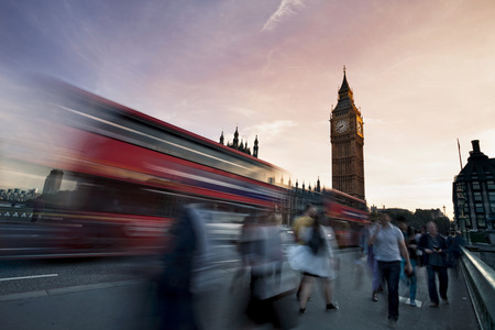Slow motion blurred tourists and and traffic on Westminster Bridge with Big Ben in background, London.の写真素材
