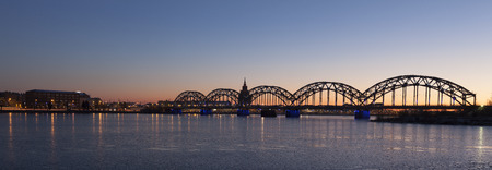 Panorama shot of Riga Railway Bridge over river Daugava during dawn timeのeditorial素材