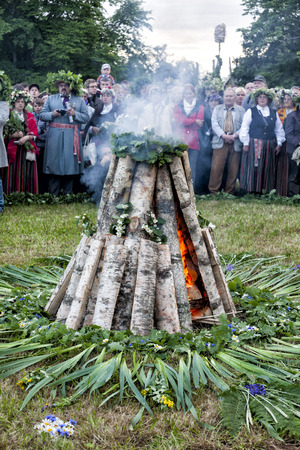 TURAIDA, LATVIA - JUNE 21, 2011: Crowd of people around bonfire celebrating Midsummer summer solstice - Jani. It is a traditional pagan festivity marking the shortest night of the year.のeditorial素材