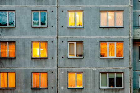 Wall with Iluminated windows. Detail of soviet era block apartment buildingの写真素材