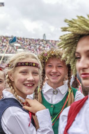 RIGA, LATVIA - JULY 11, 2015: Young Dancers in traditional costumes behind scene waiting for time to perform at the Grand Folk dance concert of Latvian Youth Song and Dance Festival in the Daugava Stadium.のeditorial素材
