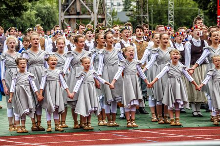 RIGA, LATVIA - JULY 11, 2015: Dancers perform at the Grand Folk dance concert of Latvian Youth Song and Dance Festival in the Daugava Stadium.のeditorial素材