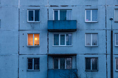Wall of multi-storey residential building with Iluminated window.の写真素材
