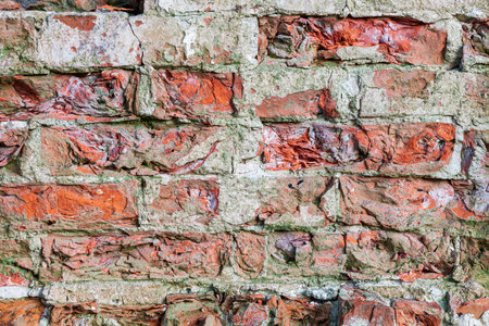 Closeup of old red damaged brick wallの写真素材