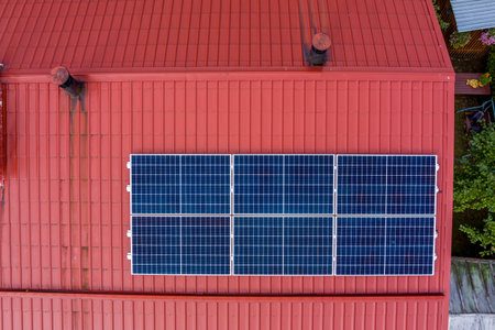 New photovoltaic solar panels on red roofの写真素材