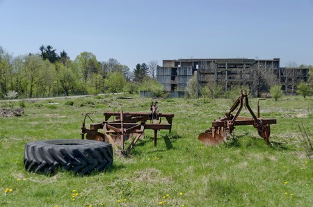 Abandoned unfinished building and farm machinery, Bulgariaの写真素材