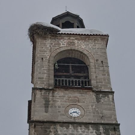 Upper part of clock tower at church in Bansko town, Bulgaria