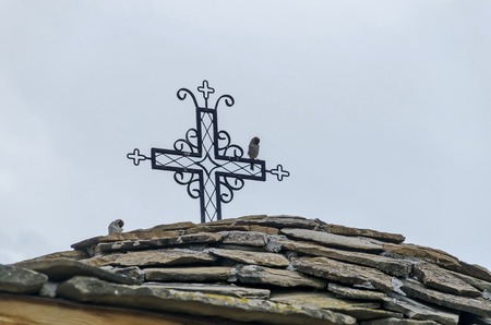 Stone roof with metal croos in monastery Sv. Sv. Cosmas and Damian