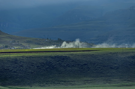 Landscape with smoke in the late afternoon  in Drakensberg mountainの写真素材